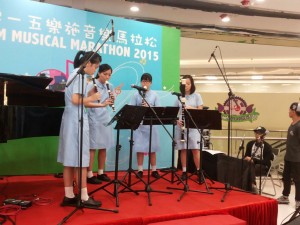 Lois, 2nd from left, playing recorders with her schoolmates.