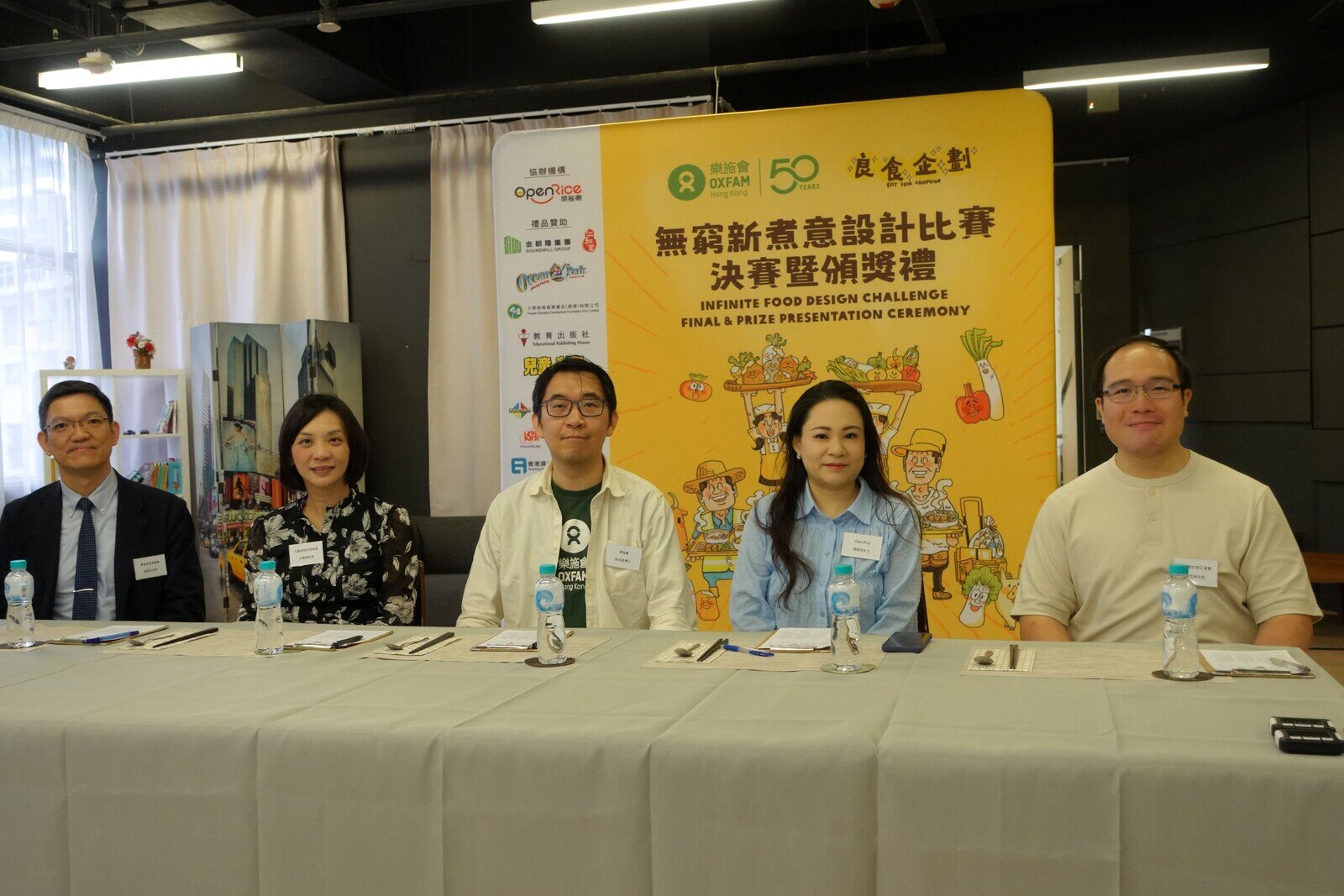 是次比赛的评审包括（左起）香港岛校长联会执委黄邵文校长、九龙地域校长联会副主席林佩仪校长、乐施会香港、澳门及台湾项目总监梁名峰博士、OpenRice开饭喇高级总监张惠玲女士、以及香港妇女劳工协会组织干事颜烈洲先生。