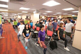 Almost 300 walkers, who attended the Oxfam Trailwalker 2018 briefing, learning warm up exercises.