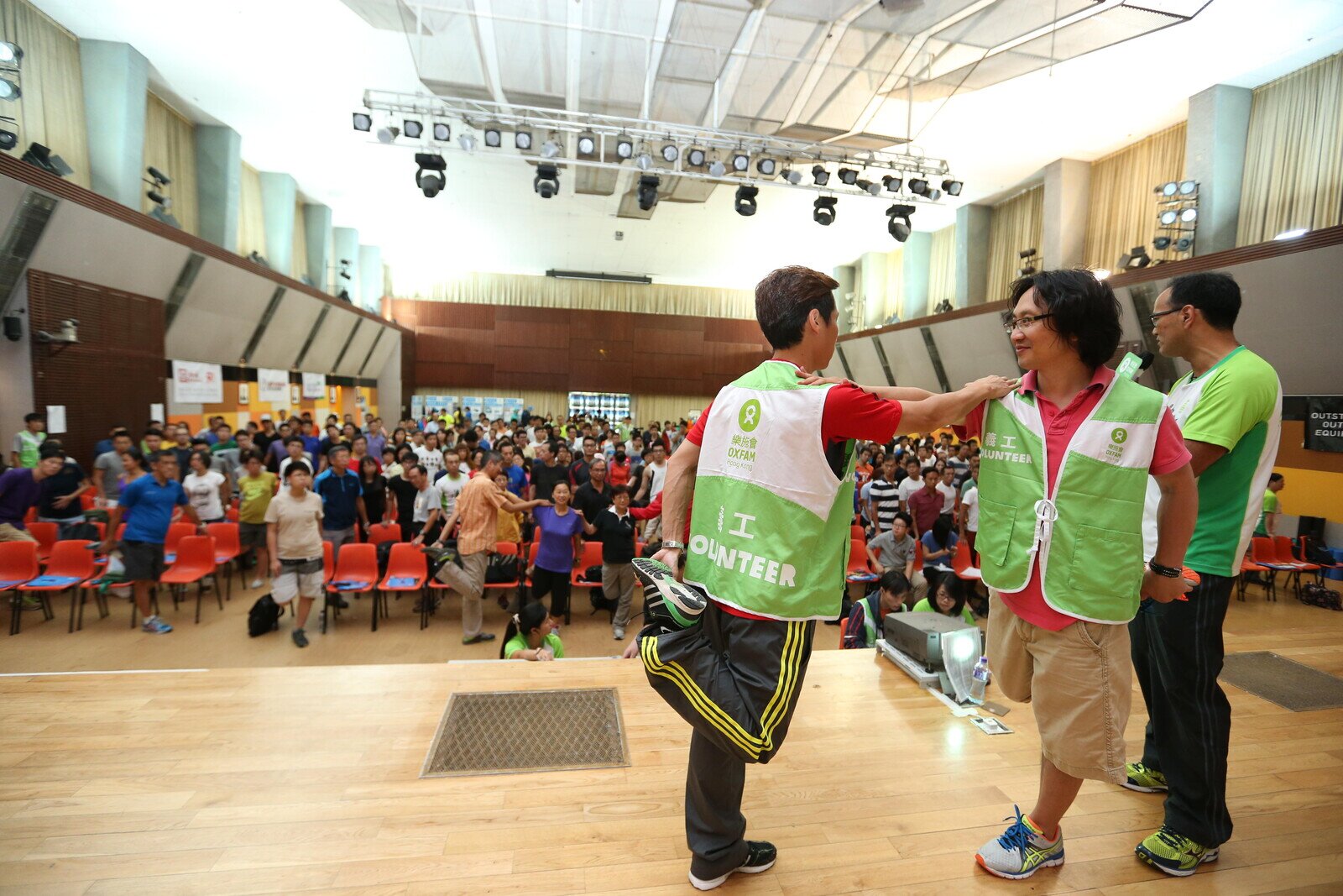 Over 300 walkers attended the Oxfam Trailwalker 2014 Briefing and they were practicing warm-up exercise.